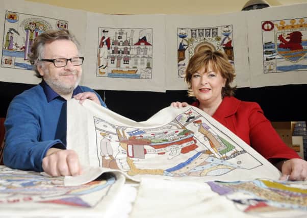 Andrew Crummy shows off some of the Disapora Tapestry alongside Cabinet Secretary Fiona Hyslop. Picture: Greg Macvean