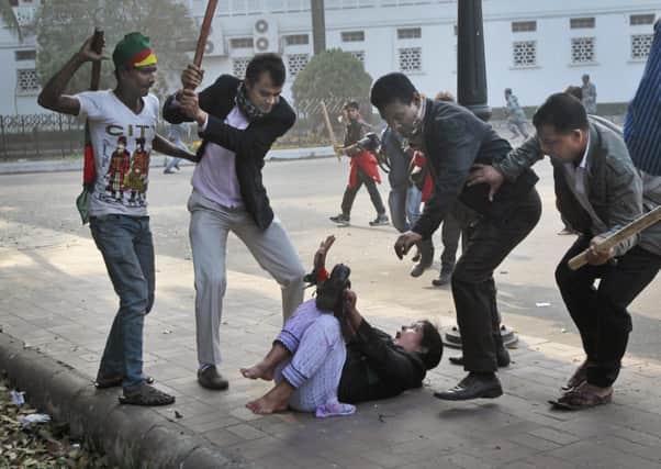 Supporters of the ruling Bangladesh Awami League beat a BNP lawmaker. Picture: AP