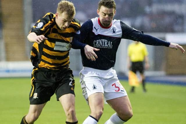 Alloa's Jonathan Tiffoney tussles for the ball with Falkirk's Mark Millar. Picture: SNS