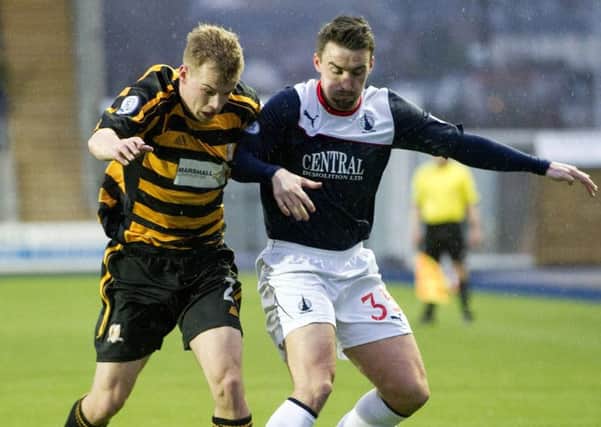 Alloa's Jonathan Tiffoney tussles for the ball with Falkirk's Mark Millar. Picture: SNS