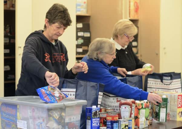 Volunteers sort packages at an Edinburgh food bank. Picture: Neil Hanna