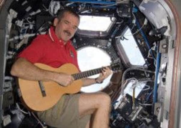 Space oddity: astronaut Chris Hadfield plays his version of the Bowie song while in orbit. Picture: Nasa