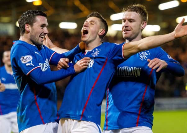 Fraser Aird (centre) celebrates giving Rangers the lead. Picture: SNS