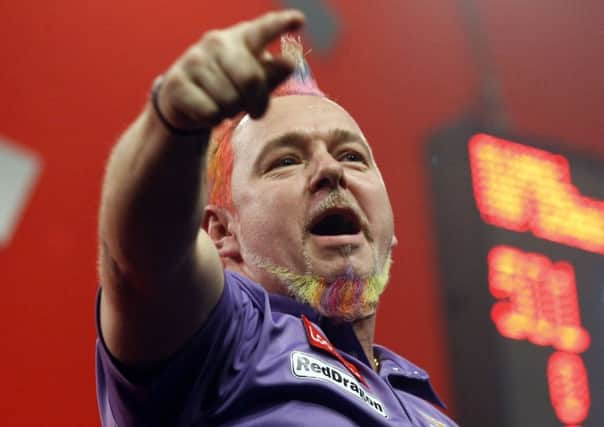 Peter Wright celebrates victory over Simon Whitlock to reach the PDA World Championship final. Picture: PA