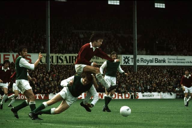 Donald Ford goes in for a challenge on Hibs' Des Bremner. Picture: SNS
