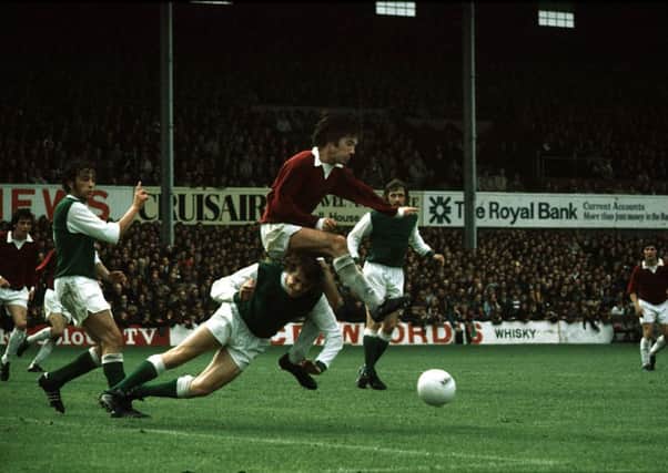 Donald Ford goes in for a challenge on Hibs' Des Bremner. Picture: SNS