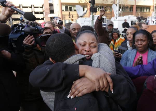 The mother of Jahi McMath, Nailah Winkfield, center, embraces her brother Omari Sealey. Picture: AP