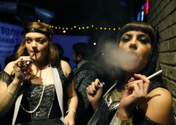 Partygoers at a New Year celebration in Denver smoke marijuana. Picture: AP