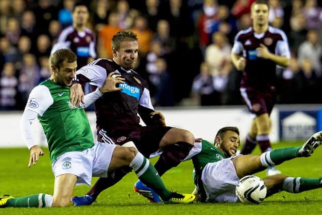Ryan Stevenson (centre) takes on two Hibs players in October's clash. Picture: SNS