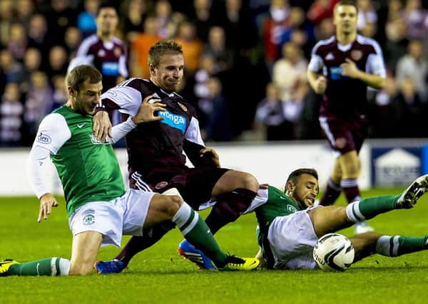 Ryan Stevenson (centre) takes on two Hibs players in October's clash. Picture: SNS