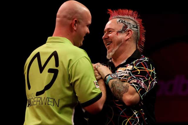 Peter Wright (R) congratulates Michael van Gerwen on his World Championship win. Picture: Getty