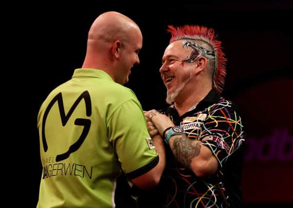 Peter Wright (R) congratulates Michael van Gerwen on his World Championship win. Picture: Getty