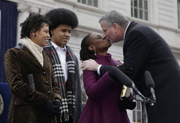 Bill de Blasio kisses his wife Chirlane McCray after taking the oath of office. Picture: AP