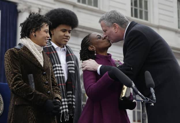 Bill de Blasio kisses his wife Chirlane McCray after taking the oath of office. Picture: AP