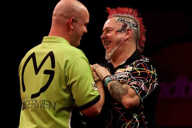 Michael van Gerwen is congratulated on his World Championship win by Peter Wright. Picture: Getty