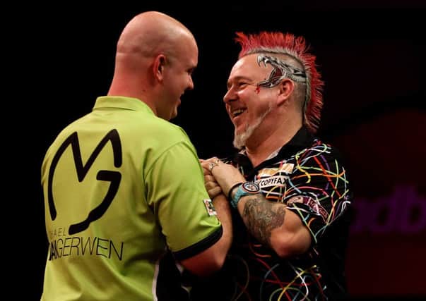 Michael van Gerwen is congratulated on his World Championship win by Peter Wright. Picture: Getty