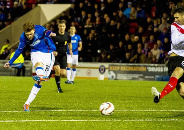 Lewis MacLeod provides an expert finish for the game's only goal. Picture: SNS