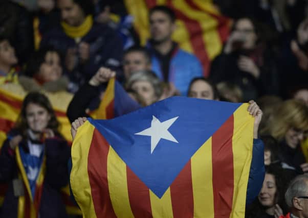 Supporters hold up the Estelada flag that for Catalonia's independence. Picture: AP