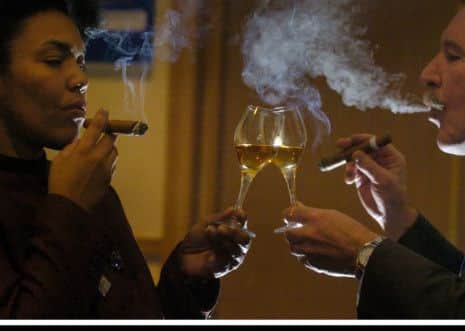 Ana Lopez, Corporate Director of Cuban Cigar compnay Hunters & Frankau samples a rare 30 year old dram, accompanied by a hand rolled special cigars, with Whisky writer and expert Charles Maclean  ... Pic Donald MacLeod 15.01.04