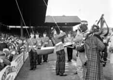 Soldiers from the Royal Scots raise the Hearts Centenary flag. Picture: Alex Brown