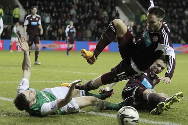 Lewis Stevenson, left, is flattened by Jordan McGhee. Picture: PA