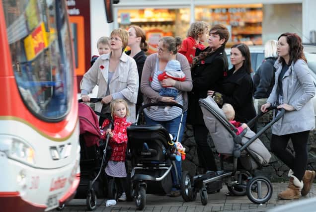 Mums wait at a bus stop. Picture: Ian Rutherford