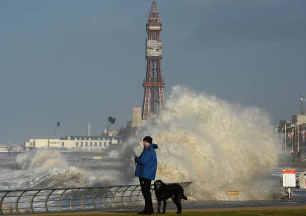 A dog walker finds a stroll along the prom at Blackpool even more bracing than usual. Picture: Getty