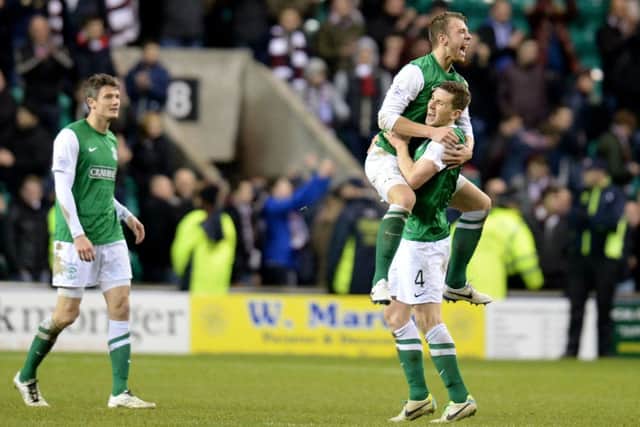 Jordon Forster celebrates Hibs' derby win with team-mate Paul Hanlon. Picture: SNS