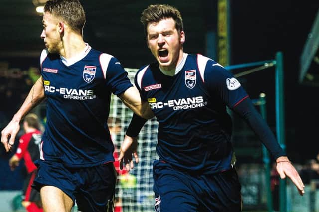 Graham Carey (right) wheels away in celebration after netting a late goal to give Ross County the lead. Picture: SNS