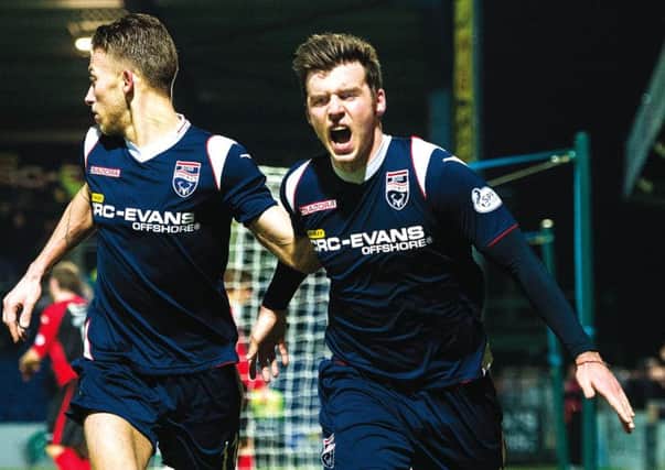 Graham Carey (right) wheels away in celebration after netting a late goal to give Ross County the lead. Picture: SNS