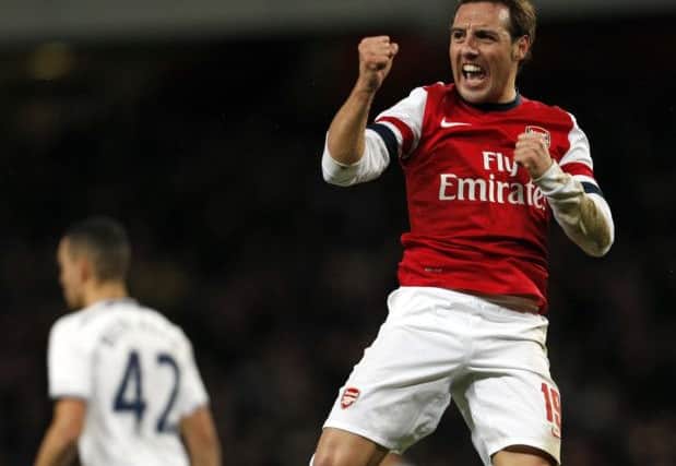 Leap of faith: Santi Cazorla celebrates scoring the opening goal for Arsenal against rivals Tottenham in the FA cup third round tie at the Emirates. Photograph: AFP