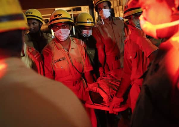 Rescue workers retrieve a body from the rubble. Picture: Reuters
