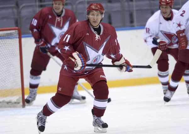 Russian president Vladimir Putin tries out the Olympic ice rink. Picture: Retuers