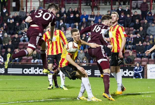 Partick Thistle defender Aaron Taylor Sinclair  does well under pressure to clear his lines. Picture: SNS