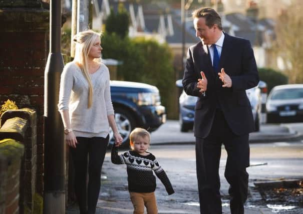 David Cameron tells Sharon Ray and daughter Maisie, two, of his plans in Southampton. Picture: PA