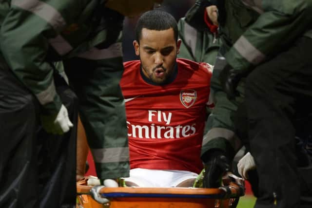 Theo Walcott is stretchered off after being injured in the FA Cup tie against Spurs. Picture: Reuters