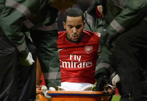 Theo Walcott is stretchered off after being injured in the FA Cup tie against Spurs. Picture: Reuters