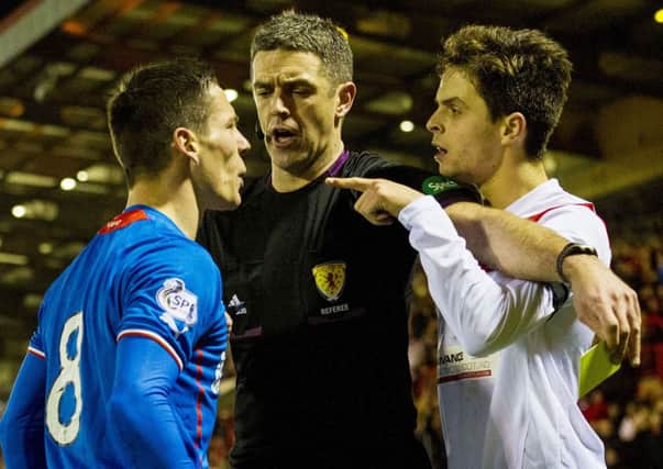 Referee Greg Aitken gets between Ian Black Jamie Bain (right). Picture: SNS