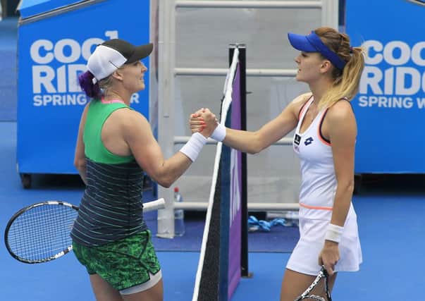 Bethanie Mattek-Sands, left, shakes hands with Agnieszka Radwanski after her win. Picture:AP