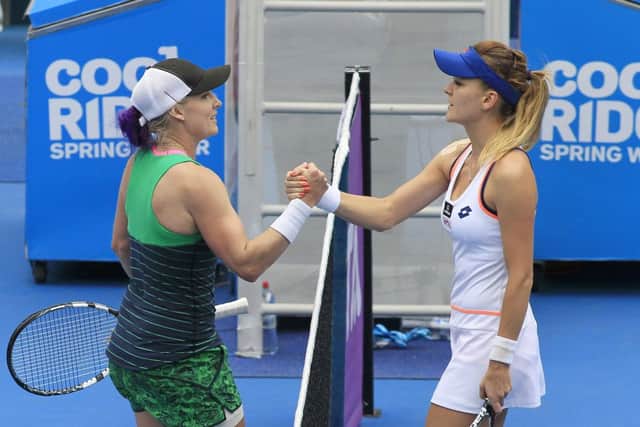 Bethanie Mattek-Sands, left, shakes hands with Agnieszka Radwanski after her win. Picture:AP