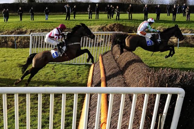 Tom Scudamore aboard Edmund Kean, right, jump clear at Leicester yesterday. Picture: Getty