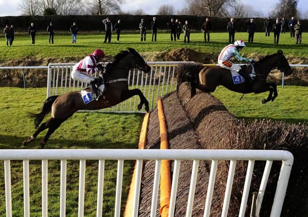 Tom Scudamore aboard Edmund Kean, right, jump clear at Leicester yesterday. Picture: Getty