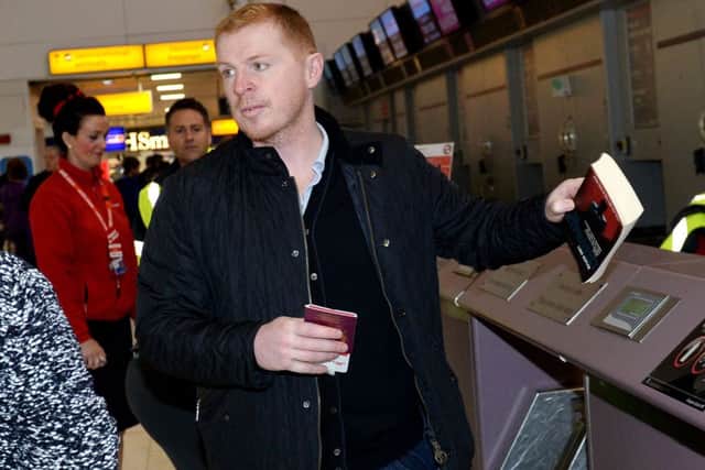 Neil Lennon checks in at Glasgow Airport as his side head for Turkey. Picture: SNS