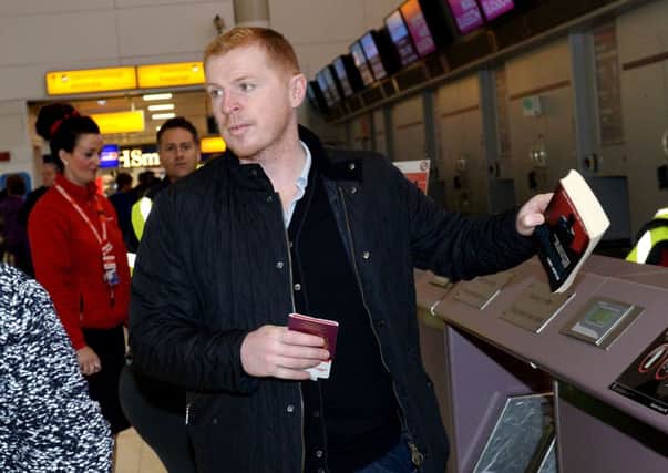 Neil Lennon checks in at Glasgow Airport as his side head for Turkey. Picture: SNS