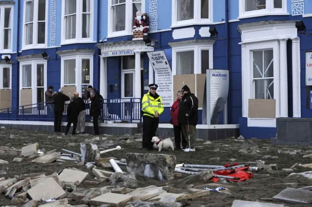 Locals examine the storm damage on the promenade at Aberystwyth. Picture: Reuters