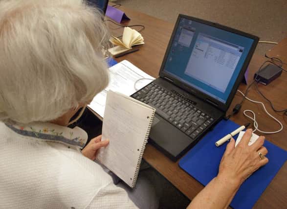 An elderly lady sits at her computer terminal during a computer class for senior citizens. Picture: Getty
