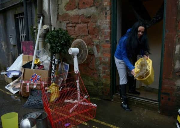 Locals clean up Whitesands in Dumfries after the river Nith burst its banks. Picture: Hemedia