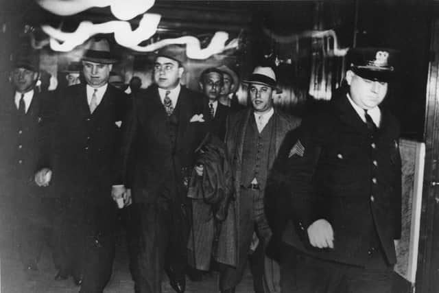 ** APN ADVANCE FOR SUNDAY, APRIL 15--FILE **Chicago crime boss Al Capone, center, leaves a courtroom in Chicago in the custody of U.S. marshals where he was facing tax evasion charges, in this file photo of Oct. 24, 1931. Marshal duty these days includes Iraq, where deputies protected witnesses during the historic trial of Saddam Hussein and assisted the U.S. military in transferring the Iraqi dictator to local authorities for execution by hanging. (AP Photo, File)
Notorious gangster Al Capone (2nd left) was jailed for tax evasion. Picture: AP
