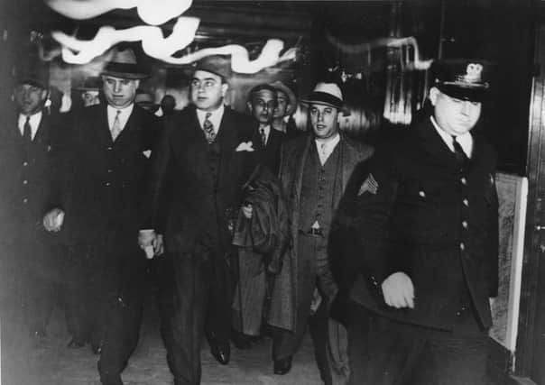 ** APN ADVANCE FOR SUNDAY, APRIL 15--FILE **Chicago crime boss Al Capone, center, leaves a courtroom in Chicago  in the custody of U.S. marshals where he was facing tax evasion charges, in this file photo of Oct. 24, 1931.  Marshal duty these days includes Iraq, where deputies protected witnesses during the historic trial of Saddam Hussein and assisted the U.S. military in transferring the Iraqi dictator to local authorities for execution by hanging. (AP Photo, File)

Notorious gangster Al Capone (2nd left) was jailed for tax evasion. Picture: AP