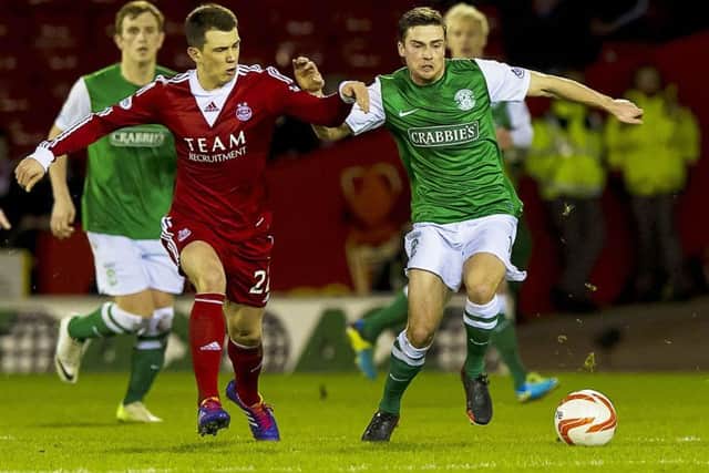 Hibernian star Lewis Stevenson holds off Ryan Jack (left). Picture: SNS